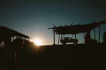 Silhouette of Pickup Truck Near Hut