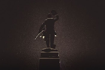 silhouette of statue against black background