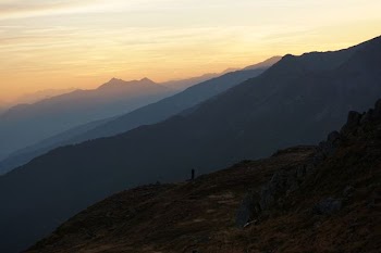 silhouette of tower on hill during daytime