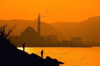 Silhouette of Two People Near Sea in Distant of Ortakoy Mosque, Istanbul Turkey