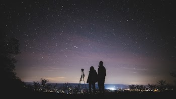 Silhouette of Two Person Standing during Nighttime