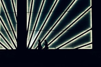silhouette of two person walking