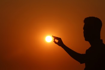 Silhouette of Woman Against Sunset