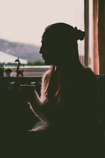 Silhouette of Woman Holding Cup