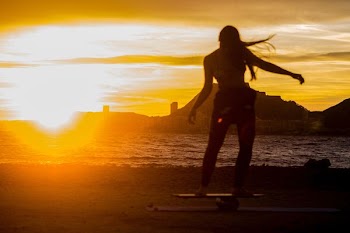 silhouette of woman standing at sunset