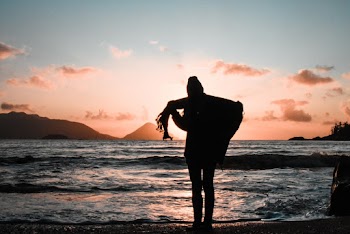 Silhouette of Woman Standing on the Seashore