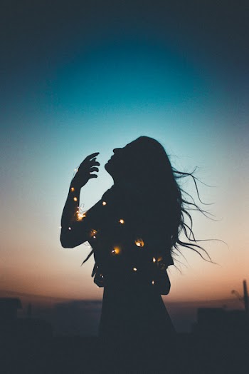 Silhouette of Woman With String Lights
