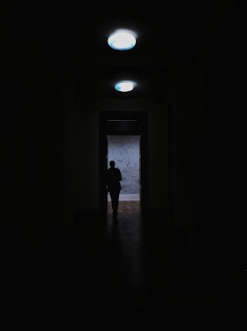 Silhouette Person Standing Beside Door