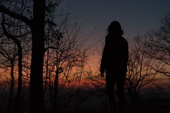 silhouette photo of a woman on sunset