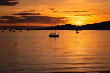 Silhouette Photo of Boat on Body of Water