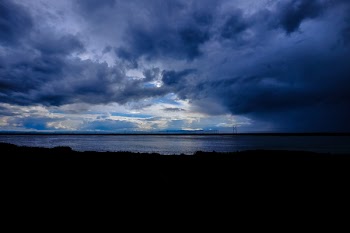 Silhouette Photo of Body of Water Under Thick Gray Clouds