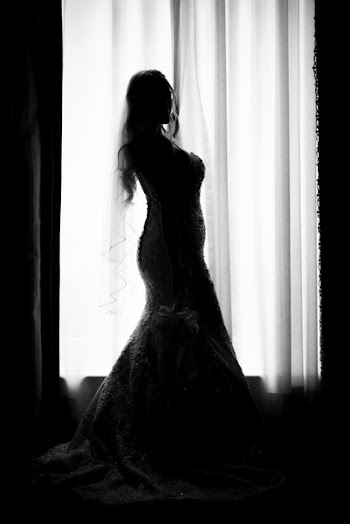 Silhouette Photo of Bride Standing Beside Window