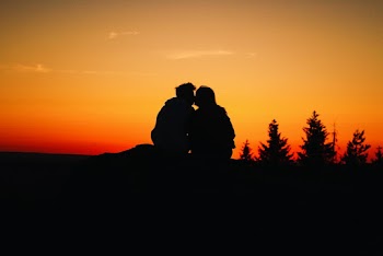 Silhouette Photo of Couple Kissing During Golden Hour