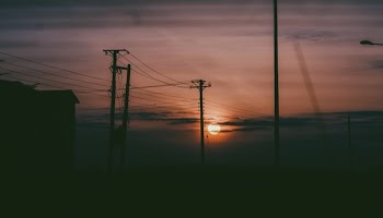 Silhouette Photo Of Electric Posts During Sunset