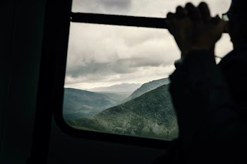 Silhouette Photo of Man Beside Window