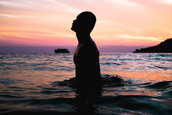 Silhouette Photo of Man on Water