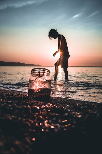 Silhouette Photo of Man Standing on Beach