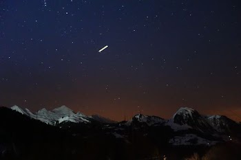 silhouette photo of mountains covered in snow at nighttime