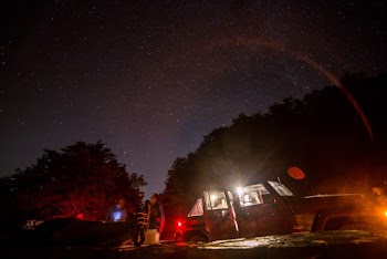 Silhouette Photo of People Beside Vehicle