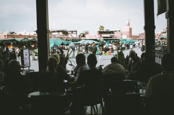 Silhouette Photo of People Sitting on Chairs
