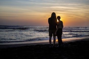 Silhouette Photo Of People Standing On Seaside