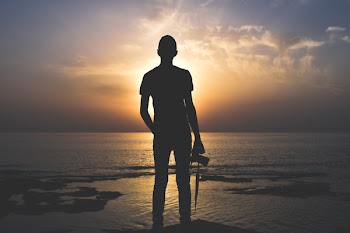 Silhouette Photo of Person Holding Camera