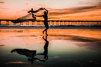 Silhouette Photo of Person Holding Scarf