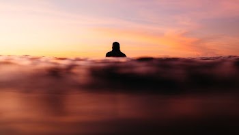 silhouette photo of person in body of water