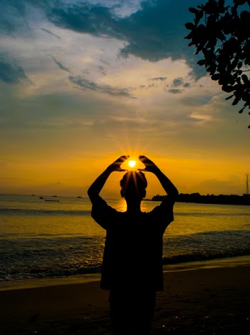 Silhouette Photo of Person Raising Hands