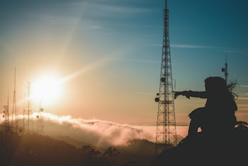 Silhouette Photo of Person Sitting and Pointing