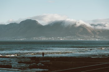 Silhouette Photo of Person Standing Near Body of Water