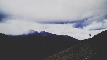 Silhouette Photo of Person Standing on Mountain