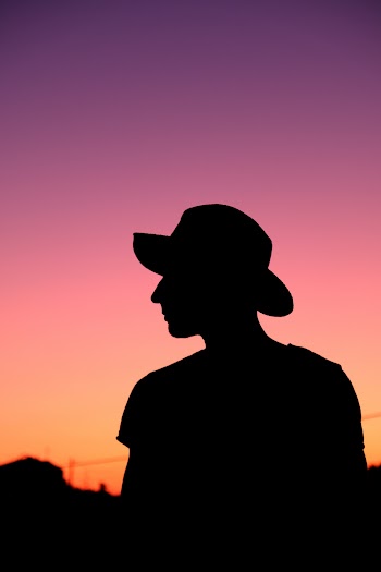 Silhouette Photo of Person Wearing Hat