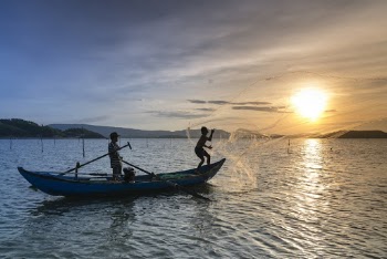 Silhouette Photo of Two Men Riding a Boat
