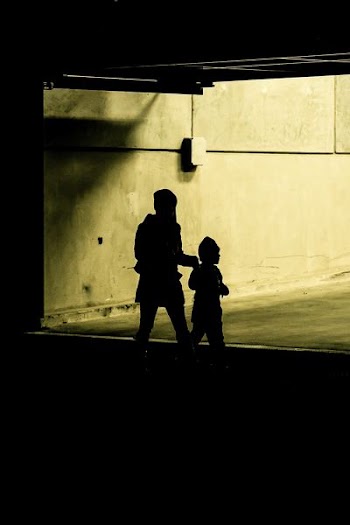 silhouette photo of woman and child inside building