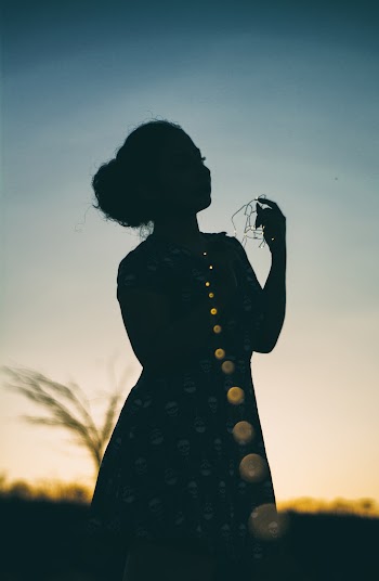 Silhouette Photo of Woman During Dawn