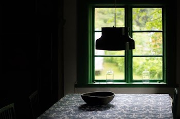 silhouette photography of bowl on grey table under lamp near window