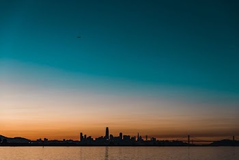 silhouette photography of buildings and body of water