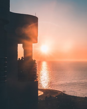 Silhouette Photography of Concrete Building Beside Water