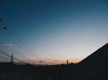 Silhouette Photography of Electric Post and Houses