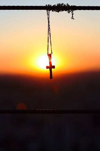 Silhouette Photography of Figaro Chain Necklace With Cross Pendant