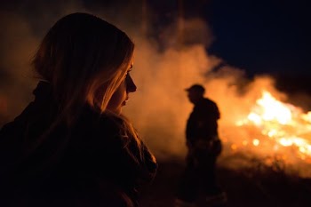 silhouette photography of man and woman nearby bush fire