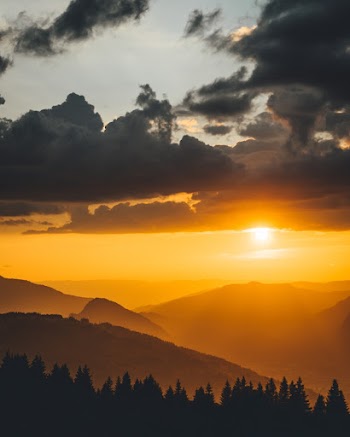 Silhouette Photography of Mountain and Trees During Golden Hour
