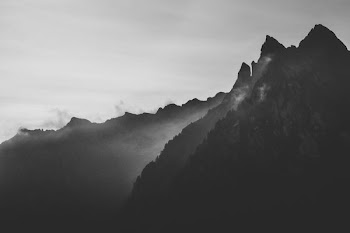silhouette photography of mountain under fog