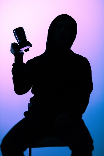 Silhouette Photography of Person Holding Slr Camera