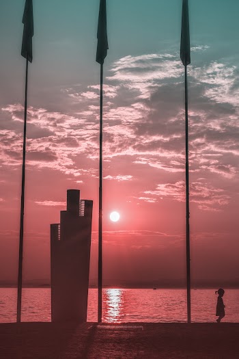 Silhouette Photography of Toddler Walking Near Water