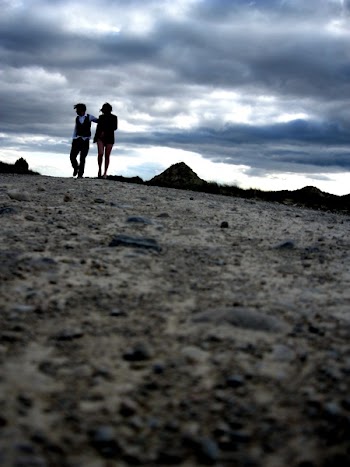 Silhouette Photography of Two Person Standing on Brown Soil