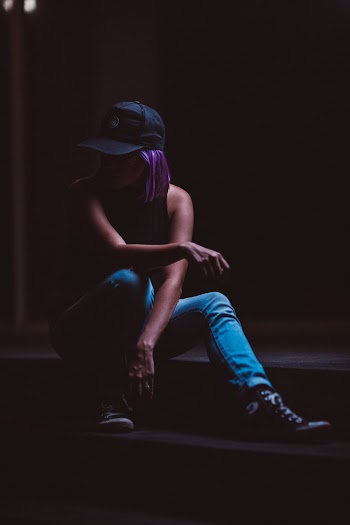 Silhouette Photography of Woman Sitting on Stairs