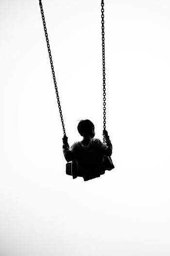 silhoutte of a baby using swing