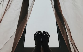 Silhoutte  of Person's Feet on Glass
